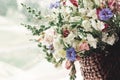 Beautiful wildflowers in wicker bag on rustic white window. colo Royalty Free Stock Photo