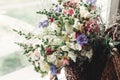 Beautiful wildflowers in wicker bag on rustic white window. colo Royalty Free Stock Photo