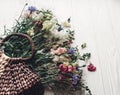 beautiful wildflowers in wicker bag on rustic white wooden background. colorful flowers in basket in light, space for text. Royalty Free Stock Photo