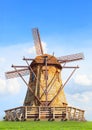 Beautiful wind mills on green grass field against natural blue s