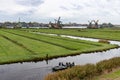 Beautiful Zaanse Schans Windmill Landscape on a Cloudy Autumn Day with a Canal and Boat in the Netherlands Royalty Free Stock Photo