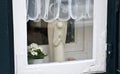 Beautiful window with figure of angel in the street of old town, Lubeck, Germany Royalty Free Stock Photo