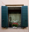 Beautiful window with flowerbox and blue shutters