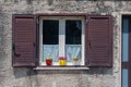 Beautiful window with flowers in an old medieval house in southern Italy