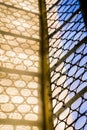 Beautiful window with forged round pattern in the german catholic church. Light and shadow Royalty Free Stock Photo