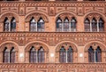 Beautiful windows on wall with relief of historical building in Tuscany