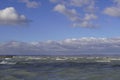 Beautiful windy day on Lake Balaton. rippling water with gray clouds and blue sky. Royalty Free Stock Photo