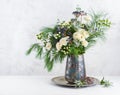 Beautiful winter bouquet in vase. Flower arrangement with roses, fir branches, winter berries, eucalyptus and eryngium. Christmas Royalty Free Stock Photo