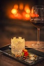 Beautiful winter dessert like castle with snowflakes and fruits served on white plate with glass of red wine, product photography