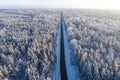Beautiful winter drone aerial landscape photo - snowy frozen trees and straight road on sunset time, Poland Royalty Free Stock Photo