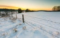 Beautiful winter fields with barbed wire fence