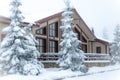 Beautiful winter forest and snow-covered house. Firs and pines in the snow, landscape Royalty Free Stock Photo