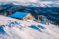 Beautiful winter landscape with abandoned log cabin in Carpathian mountains Royalty Free Stock Photo