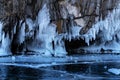 Beautiful winter landscape with blue ice cave grotto and frozen clear icicles. Lake Baikal, Olkhon island, Russia. Royalty Free Stock Photo