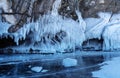 Beautiful winter landscape with blue ice cave grotto and frozen clear icicles. Lake Baikal, Olkhon island, Russia. Royalty Free Stock Photo