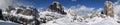 Beautiful winter landscape in the Cortina d`Ampezzo Dolomites. Skiers in front of Tofana di Rozes and the Cinque Torri group.