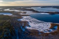 Beautiful winter landscape - drone aerial photo sunset time - frozen Wigry lake, forest and sun reflections