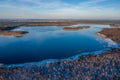 Beautiful winter landscape - drone aerial photo sunset time - frozen Wigry lake, forest and sun reflections