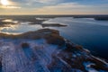 Beautiful winter landscape - drone aerial photo sunset time - frozen Wigry lake, forest and sun reflections