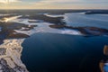 Beautiful winter landscape - drone aerial photo sunset time - frozen Wigry lake, forest and sun reflections