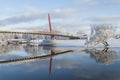 Beautiful winter landscape with footbridge and nice reflection in water of river Royalty Free Stock Photo