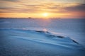 Beautiful winter landscape with frozen lake, crack and sunset Royalty Free Stock Photo
