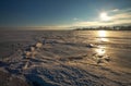 Beautiful winter landscape with frozen lake and sunset sky Royalty Free Stock Photo