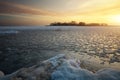 Beautiful winter landscape with frozen lake and sunset sky. Royalty Free Stock Photo