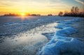 Beautiful winter landscape with frozen lake and sunset sky. Royalty Free Stock Photo