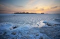 Beautiful winter landscape with frozen lake and sunset sky. Royalty Free Stock Photo