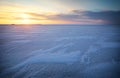 Beautiful winter landscape with frozen lake and sunset sky. Royalty Free Stock Photo