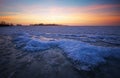 Beautiful winter landscape with frozen lake and sunset sky. Royalty Free Stock Photo