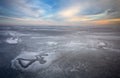 Beautiful winter landscape with frozen lake and sunset Royalty Free Stock Photo