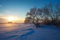 Beautiful winter landscape with frozen lake, trees and sunset Royalty Free Stock Photo