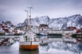 Beautiful winter landscape of harbor with fishing boat and traditional Norwegian rorbus Royalty Free Stock Photo
