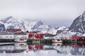 Beautiful winter landscape of harbor with fishing boat and traditional Norwegian rorbus