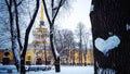 Beautiful winter landscape with heart of snow on tree trunk and Spire of Admiralty building, Saint Petersburg, Russia Royalty Free Stock Photo