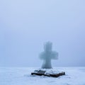 Beautiful winter landscape with Ice Cross on frozen river on foggy morning I Royalty Free Stock Photo