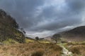 Beautiful Winter landscape image looking along valley from Crimpiau towards Mount Snowdon in the distance