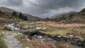 Beautiful Winter landscape image looking along valley from Crimpiau towards Mount Snowdon in the distance