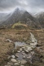 Beautiful Winter landscape image looking along valley from Crimpiau towards Mount Snowdon in the distance