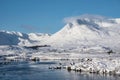 Beautiful Winter landscape image looking towards Scottish Highlands mountain range across Loch Ba on Rannoch Moor Royalty Free Stock Photo