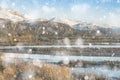 Beautiful Winter sunrise landscape image of Mount Snowdon and other peaks in Snowdonia National Park in heavy snow storm