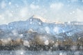 Beautiful Winter sunrise landscape image of Mount Snowdon and other peaks in Snowdonia National Park in heavy snow storm