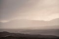 Beautiful Winter landscape image of view along Rannoch Moor during heavy rainfall giving misty look to the scene Royalty Free Stock Photo