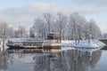 Beautiful winter landscape with cafeteria in shape of boat with nice reflection in water Royalty Free Stock Photo
