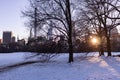 Winter Landscape and Midtown Manhattan Skyline along the Snow Covered Sheep Meadow at Central Park in New York City during a Sunse Royalty Free Stock Photo