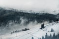 Beautiful winter landscape in the mountains. Sunrise. Carpatian valley with fog and snow. Carpathian winter mountains. Early morni