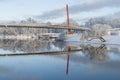 Beautiful winter landscape with pedestrian bridge and nice reflection in water of river Royalty Free Stock Photo