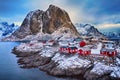 Winter landscape of picturesque fishing village with red rorbus in the mountains of Lofoten islands Royalty Free Stock Photo